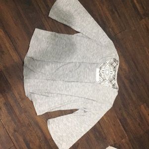 A gray cardigan/sweater